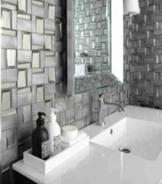 Sink with hand soaps, mirror and grey tile wall