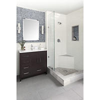 Thumbnail image of Bathroom area fully tiled from floors to walls this bathroom features a walk-in shower with Carrara natural marble in Grays and whites with a soft tan clouding for both baseboard shower curb shower pan shower seat all corresponding the bathroom floor is a 12 by 24 crosshatch linen field in Gray with a white background the niche and upper part of wainscoting is a penny round increase in subtle steely Blues the rest of the shower walls and wainscoting are done in a white elongated subway tile with a natural edge profiles are done in a denim colored square pencil this area has a dark rich wood vanity with a white top all fixtures are a gloss Chrome.