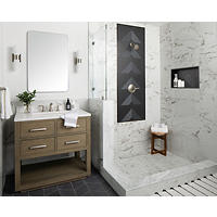 Thumbnail image of Bathroom area with walk-in shower with a porcelain bodied- faux marble looking tile on walls with black picture frame accent around shower fixtures and in the back of recessed niche shower pan is of matching tile and a smaller caliber like wall tile - wainscoting tile to match shower wall tile  surrounds rest of room small shower stool sits in shower area bathroom vanity is of natural wood fixtures of our of a brushed silver metal mirror and sconces match.