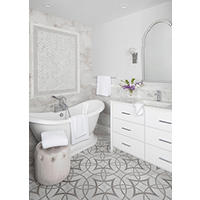 Thumbnail image of Bathroom area using natural marble waterjet cut mosaic tile in a starburst and circular pattern on the floor natural marble accent wall in wainscoting using natural profiles as baseboard and chair rails used around picture frame accent above soaking tub with mosaic pattern within and framed in a taupe/grey subway tile vanity tub and plush bathroom stool all in white accented in cut flowers in Chrome fixtures. Tile is in taupe white sand beige tones.