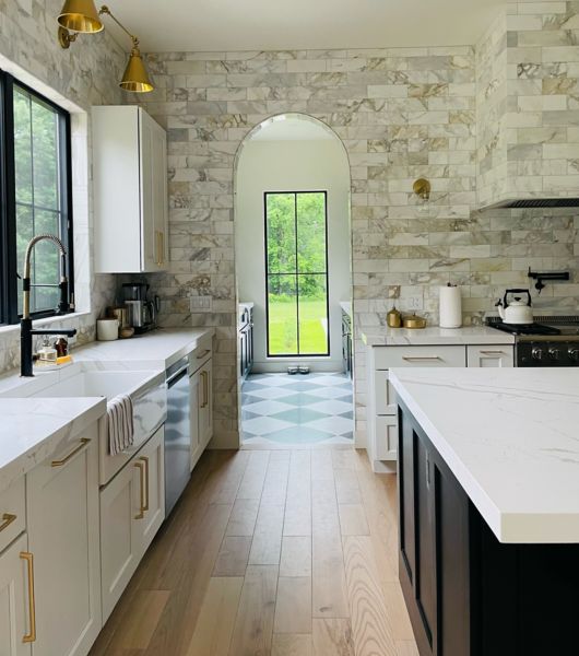 Galley kitchen with arched doorway and window