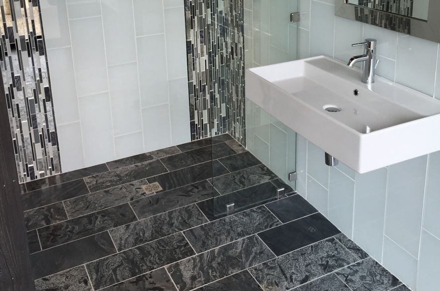 shades of dark grey bathroom tiles.