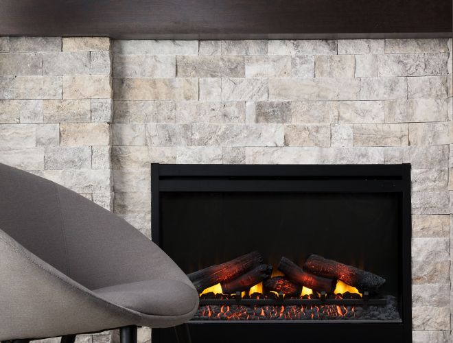 Textured grey and tan travertine stacked stone fireplace with wood-look wall tile.