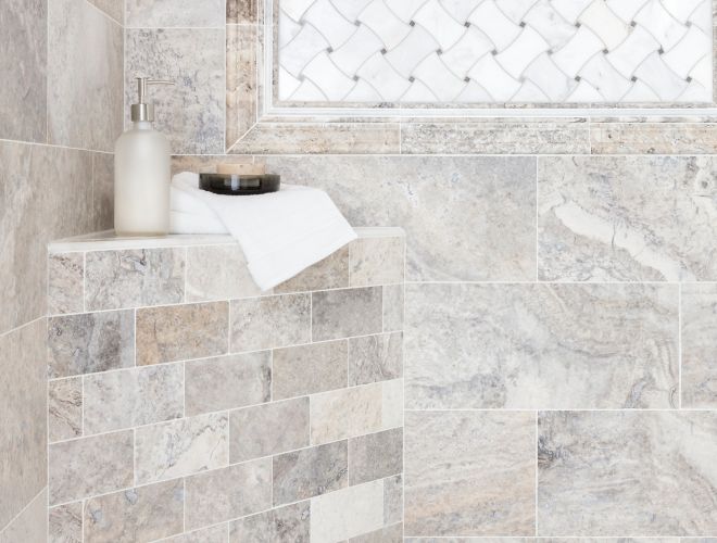 Shower with grey travertine and marble tile.