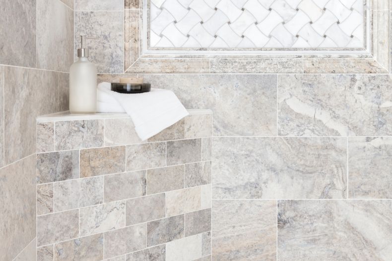 Shower with grey travertine and marble tile.