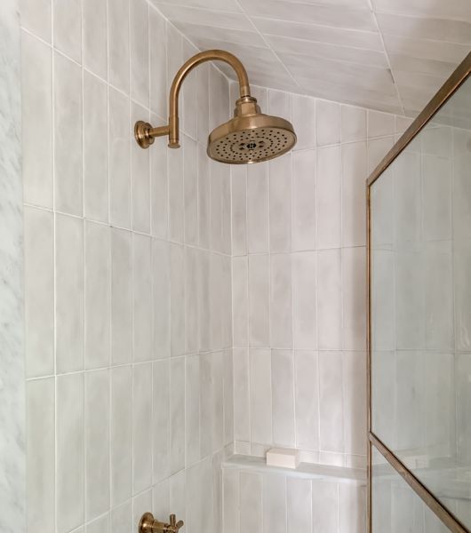 Shower with white handmade-look subway tile.