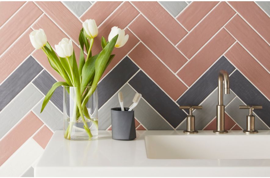 Pink and grey ceramic subway tiled bathroom.