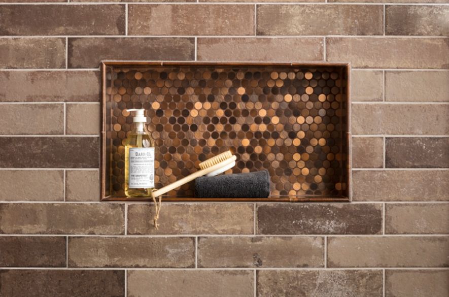 copper brick wall with shower niche.