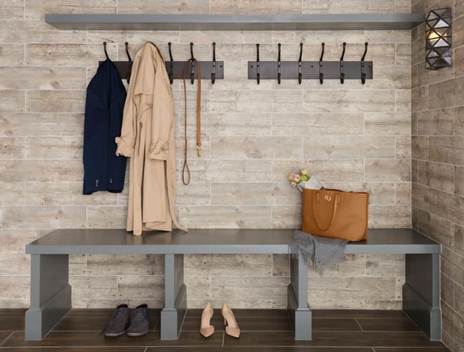 Entry way with wood-look wall and floor tile.