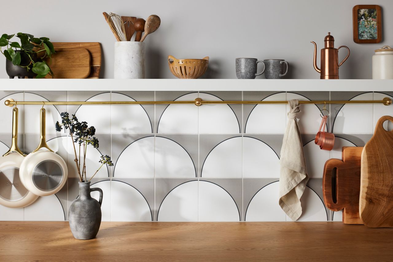 Kitchen backsplash with grey and white geometric half-circle tile.