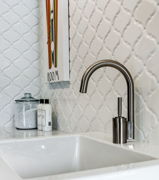 Marble tiles surround bathroom sink.