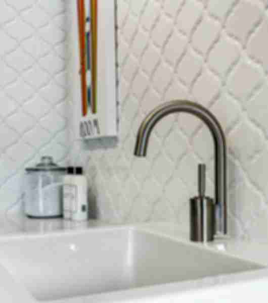 Marble tiles surround bathroom sink.