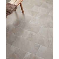 Thumbnail image of Overhead shot of floor tile featuring a ceramic rectangular tile with a stone look finish in soft Grays and taupes over a whitish ivory background this style is also staggered in thirds to add interest this tile is also staggered in thirds for added interest.