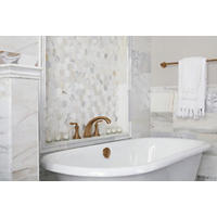 Thumbnail image of Bathroom area with Italian marble has a polished finish and displays a cloudy white base with gold veining in several sizes and profiles to make am elegant look around this soaker tub.