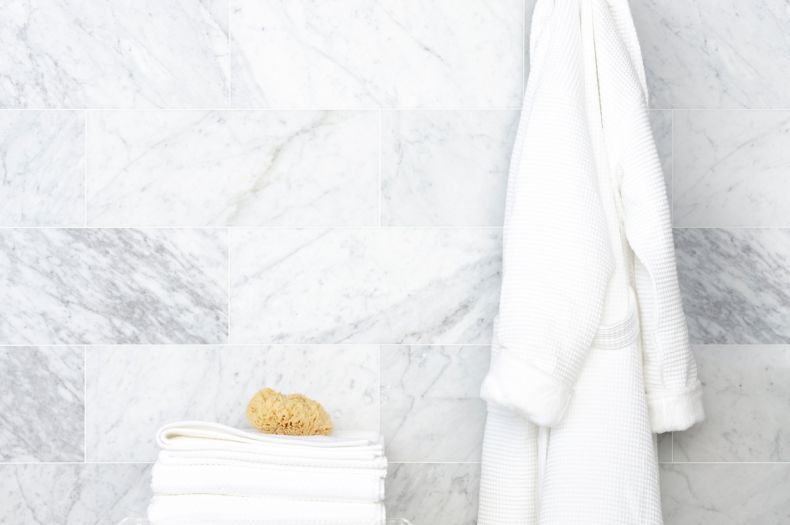 White marble wall with hanging robe.