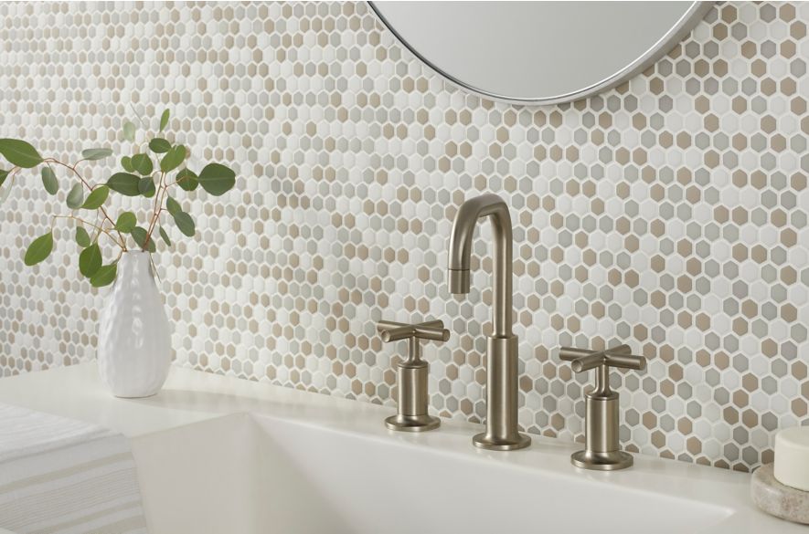 Neutral glass mosaic bathroom backsplash.