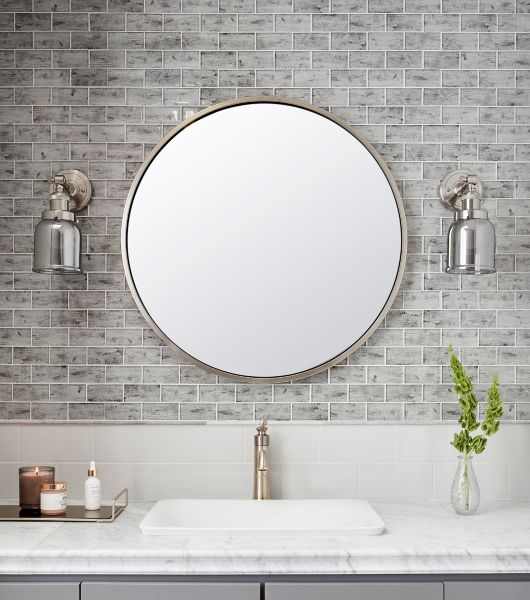 This Amalfi mosaic combines the modern sheen of glass and the appearance of a weathered wood into one stunning tile. Featuring rectangular pieces of glass on top of a wood-grain pattern, this tile adds classic design and easy-care properties to backsplash as and upper accent.  Long subway tile below in white divided by a marble trim piece.