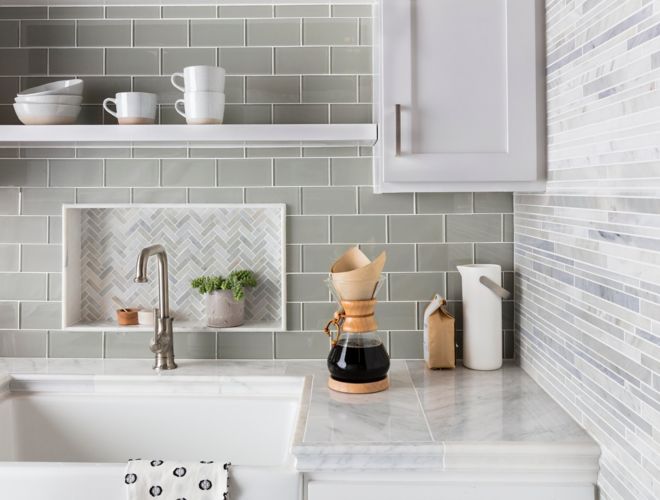 Green glass subway tile kitchen backsplash with herringbone mosaic accent.