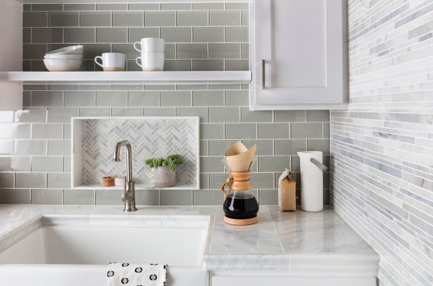 Green glass subway tile kitchen backsplash with herringbone mosaic accent.