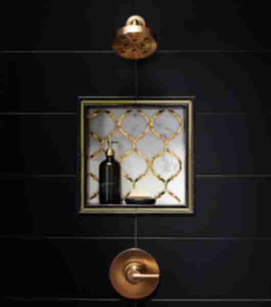Antique Mirror glass and stone mosaic infuses any design with metallic and reflective elements. black marble contains subtle white veining running throughout to give it that classic marble look and frames gold glass liner perfectly around this shower niche.