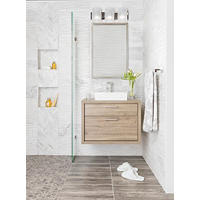 Thumbnail image of Bathroom with white marble walls and warm wood accents.