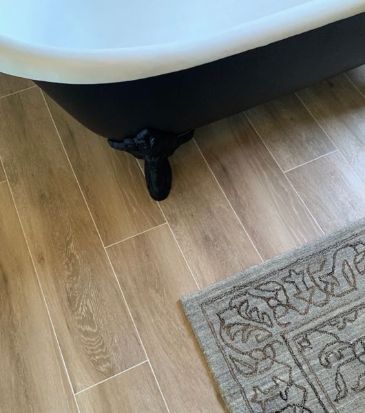 Bathroom with wood-look porcelain tile floor.