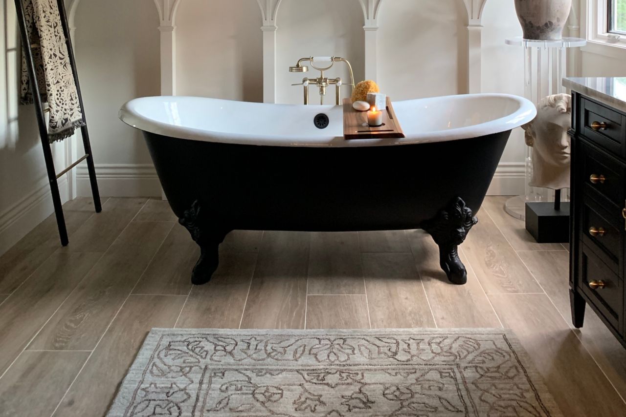 This farmhouse-style bathroom features porcelain floor tiles in a realistic wood-look beige tone.