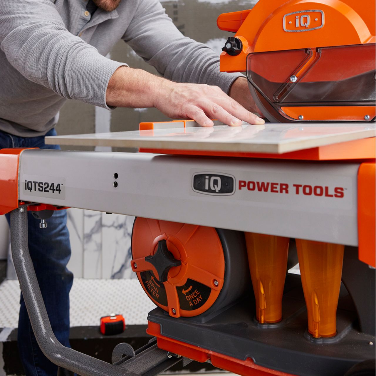 A pro installer cutting tile on an iQ tile saw.