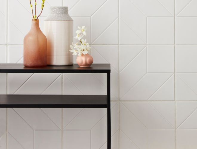 Modern and feminine entry way with white, geometric wall tile.