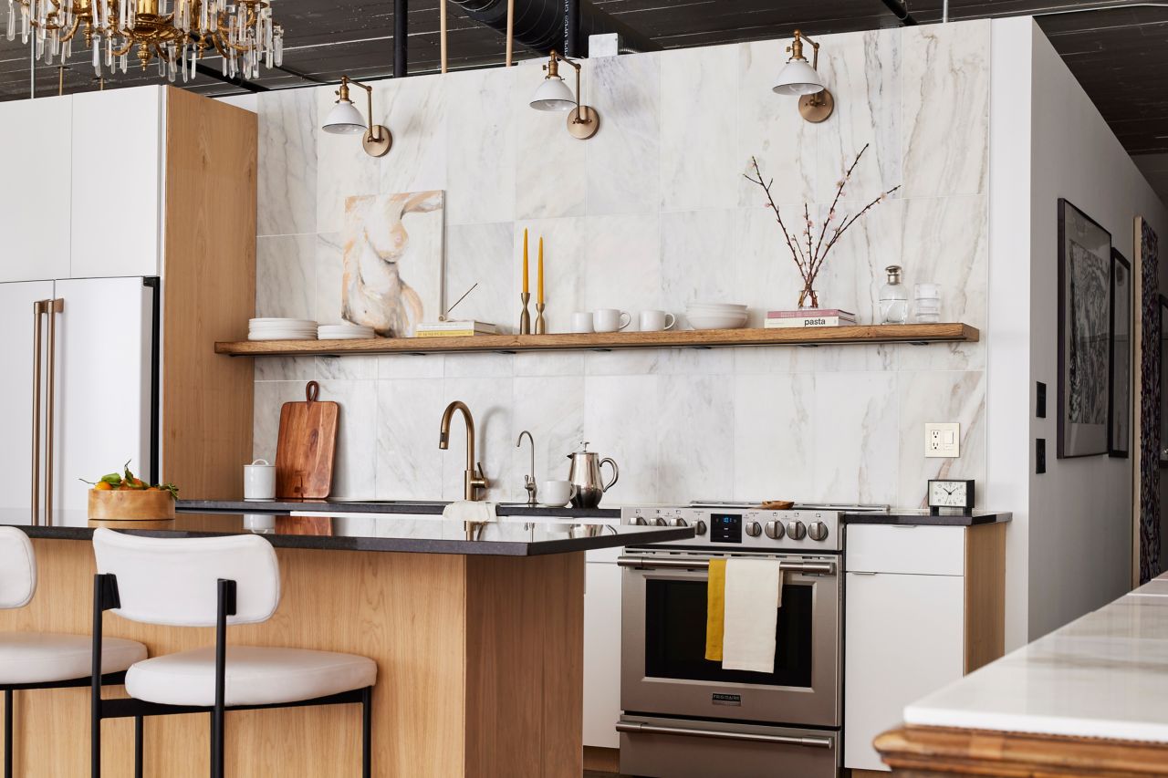 Loft kitchen with tall large-format tiled wall.