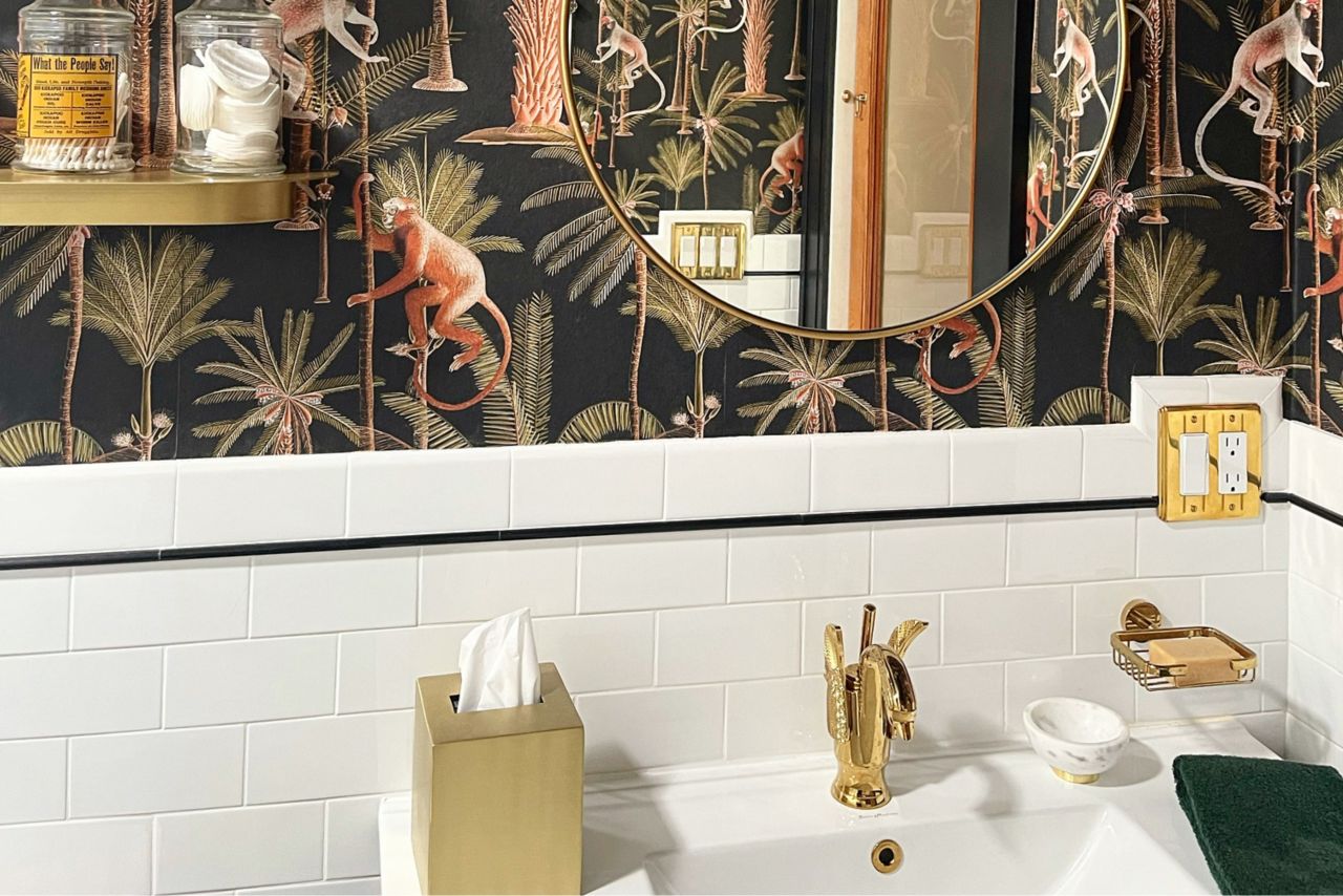 This retro bathroom features a white subway tile backsplash with a band of black trim.