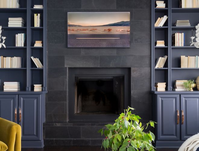This modern, stately fireplace features black slate tile.
