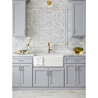 Thumbnail image of Kitchen with porcelain tile on floor resembling wood planks. Marble counter tops set under a backsplash of marble subway tile accenterd with mother of pearl and marble mosaic deco framed with marble and gold profiles.