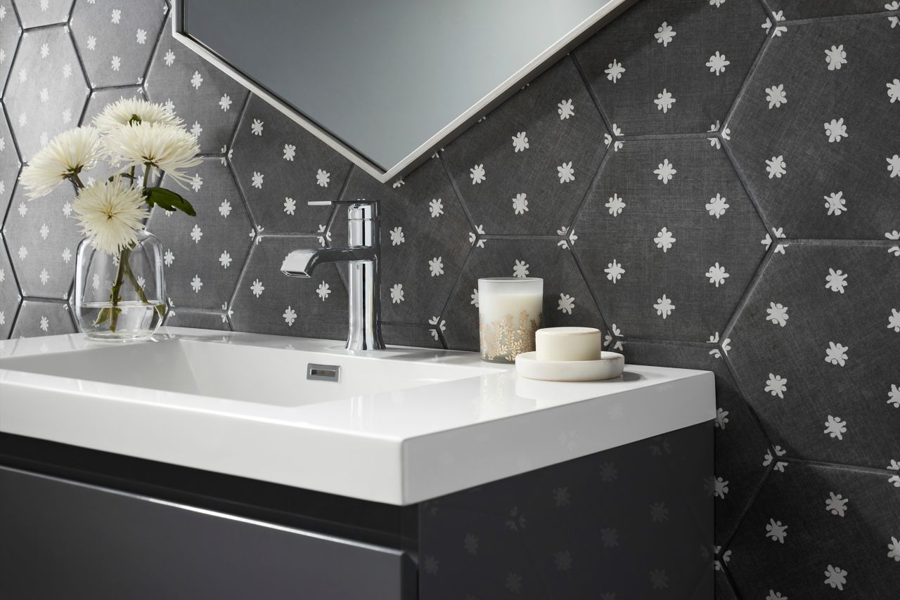 Detail of a vanity wall with charcoal hexagon tile