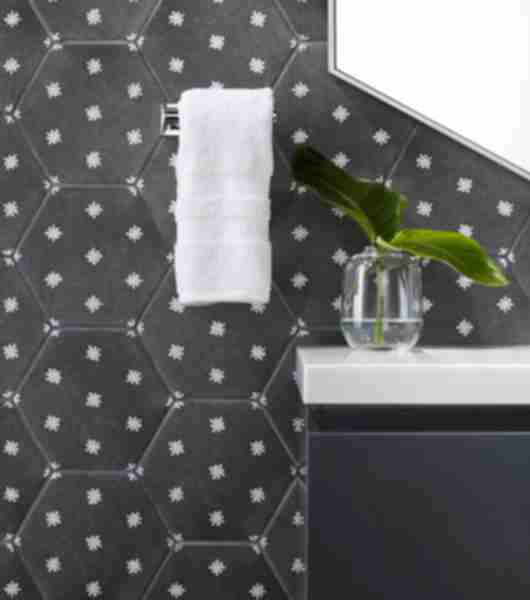 Detail of a vanity wall with charcoal hexagon tile