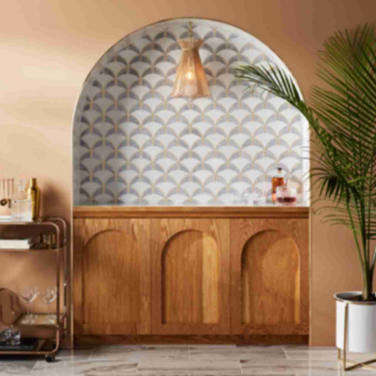 An elegant home bar backsplash features Art Deco-inspired waterjet marble mosaic tile in shades of white and grey marble, with gold accents.