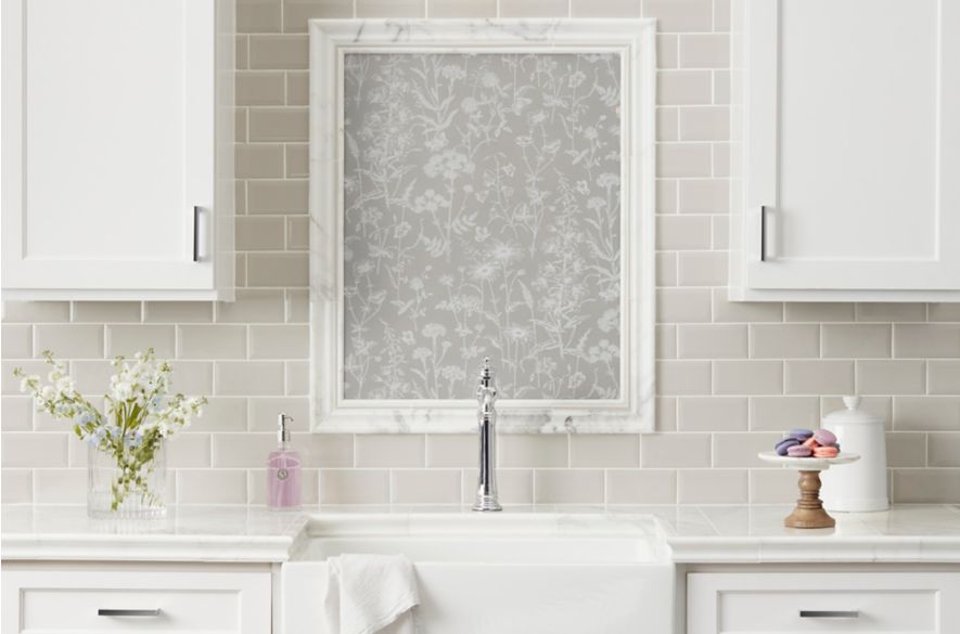 Monochromatic cream kitchen with patterned tiles.