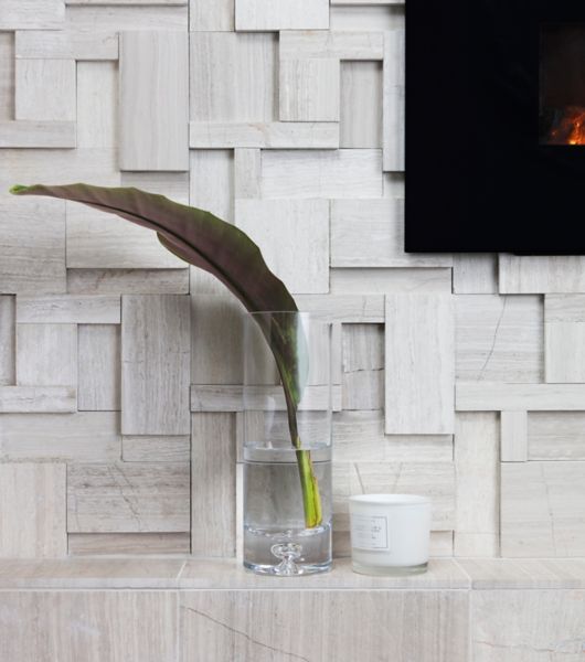 Sculptural limestone fireplace detail of mantle.