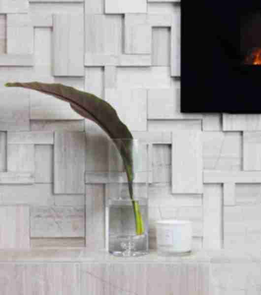 Sculptural limestone fireplace detail of mantle.