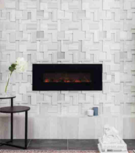 The wall behind this modern fireplace is covered in a geometric limestone mosaic tile with a three-dimensional combination of tiles in different colors and depths.