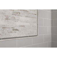 Thumbnail image of Detail view of tiled accent wall with subway tile and frame of a marble mosaic with both marble and glass profiles.