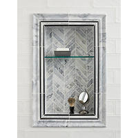 Thumbnail image of Close up view of shower niche with black, grey and white stone profiles and grey and neutral toned marble chevron pattern accents the back of niche. Wall is ceramic, white ,textured and glossy 4" x 12" tile.