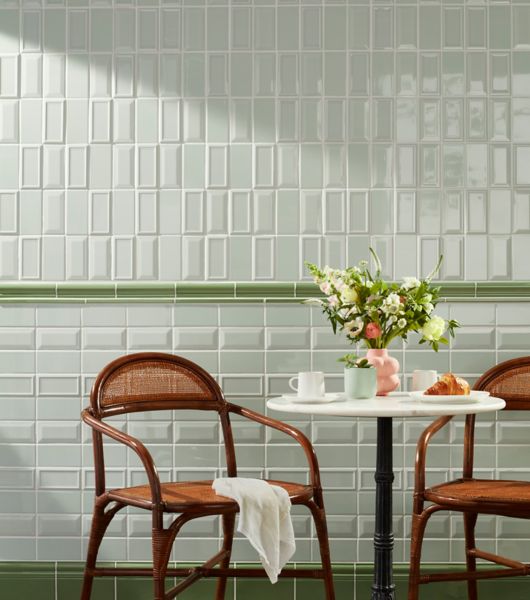 Green kitchen wall tile in vertical and horizontal stack with table and chairs