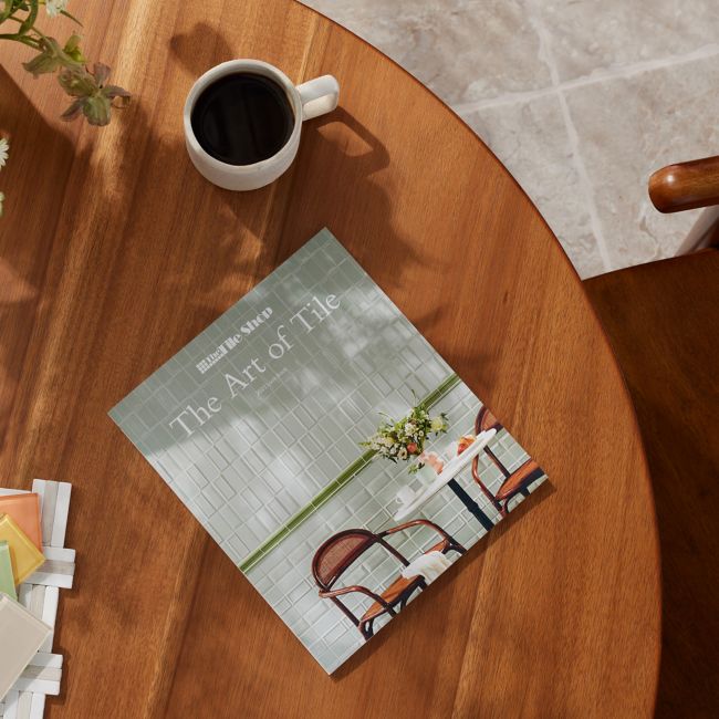The Marble Shop 2022 Look Book on coffee table surrounded by greenery inside home setting
