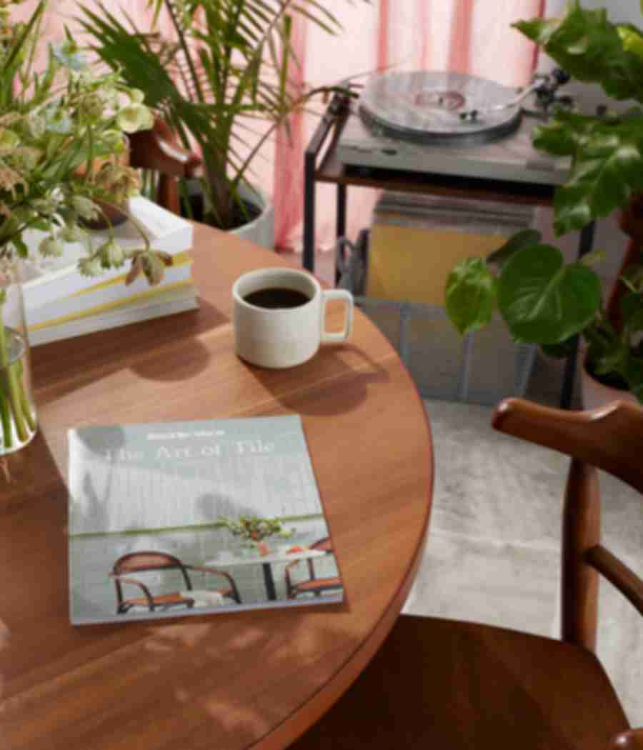 The Tile Shop 2022 Look Book on coffee table surrounded by greenery inside home setting