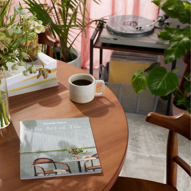 The Marble Shop 2022 Look Book on coffee table surrounded by greenery inside home setting