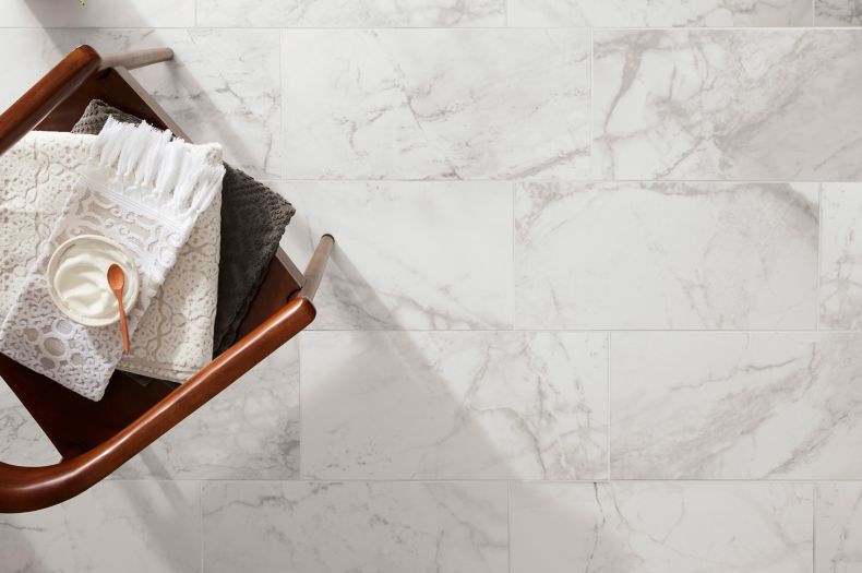 Bright spa-styled room with marble-look floor tile.