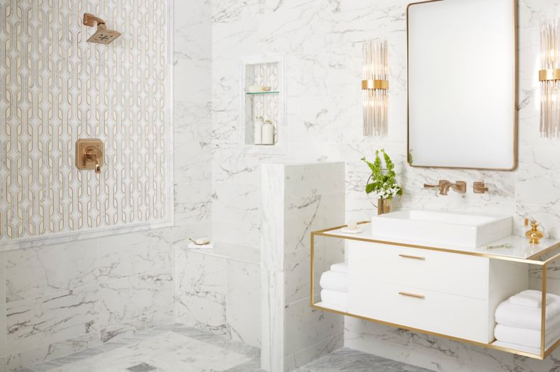 Elegant and glamorous bathroom with white marble and gold accents.