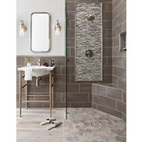 Thumbnail image of Bathroom tiled in warm tones.  Floor is wood look tile both rectangle and hexagonal shapes. Wall tile is horizontal staggered rectangles and deco frame is a metal and glass mosaic framed in metal pencil tiles.