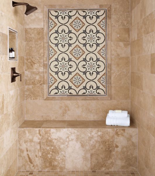 Walk in shower with Travertine stone tile and a feature frame with a porcelain patterned tile framed in both metal and stone profiles.  Recessed niche and shower bench complete the area.